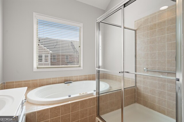 full bathroom with a bath, vanity, and a shower stall