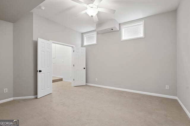 unfurnished bedroom with a ceiling fan, carpet floors, baseboards, and visible vents