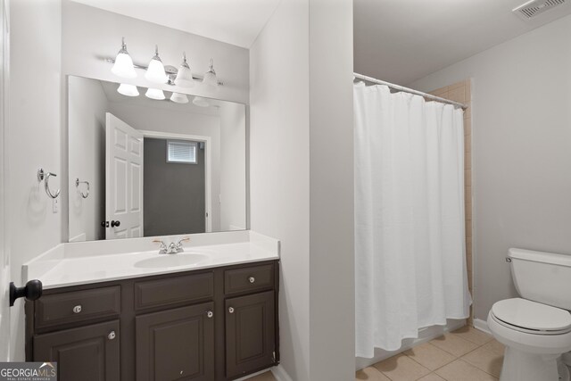 bathroom featuring visible vents, a shower with shower curtain, toilet, vanity, and tile patterned flooring