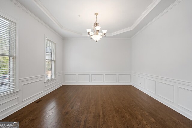unfurnished room featuring dark wood-style flooring, a notable chandelier, and crown molding