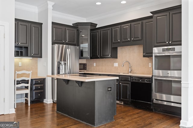 kitchen featuring light countertops, crown molding, a center island, dark wood-style floors, and black appliances