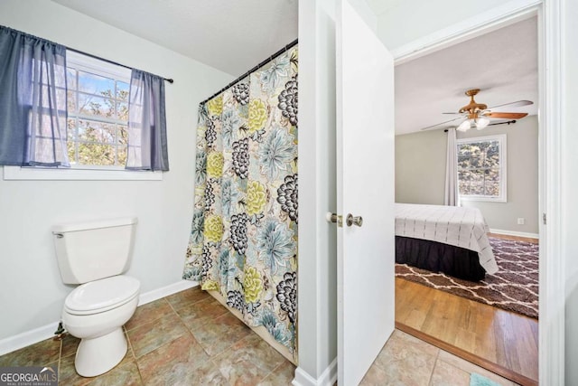ensuite bathroom featuring ensuite bathroom, baseboards, ceiling fan, and toilet