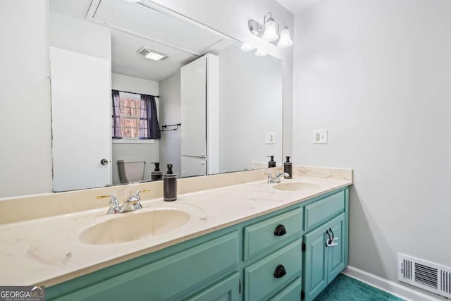 full bath with double vanity, a sink, and visible vents