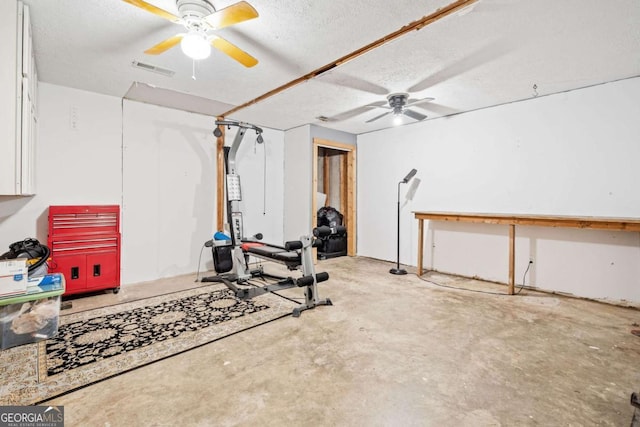 workout area featuring a textured ceiling, visible vents, and a ceiling fan