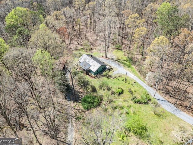 birds eye view of property with a forest view