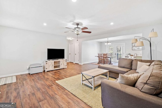 living area featuring baseboards, ceiling fan, wood finished floors, and recessed lighting