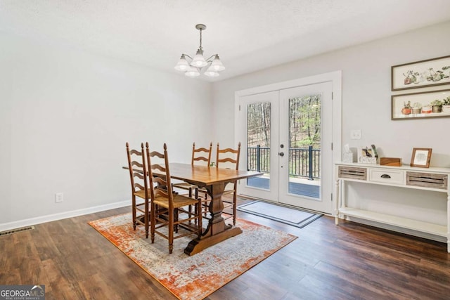 dining space featuring visible vents, a chandelier, baseboards, dark wood finished floors, and french doors