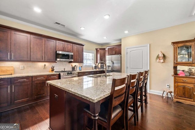 57 Cedarcrest Village Ln, Acworth, GA 30101 - kitchen featuring stainless steel appliances, a sink, a breakfast bar, ornamental molding, and dark wood-style flooring