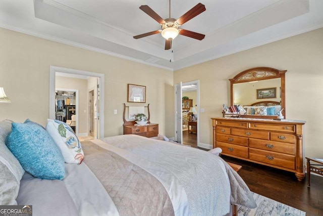 57 Cedarcrest Village Ln, Acworth, GA 30101 - bedroom with a raised ceiling, dark wood-type flooring, ornamental molding, a walk in closet, and ceiling fan