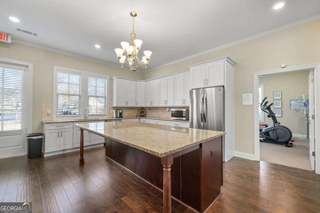 57 Cedarcrest Village Ln, Acworth, GA 30101 - kitchen featuring appliances with stainless steel finishes, dark wood-style floors, a chandelier, white cabinetry, and a center island