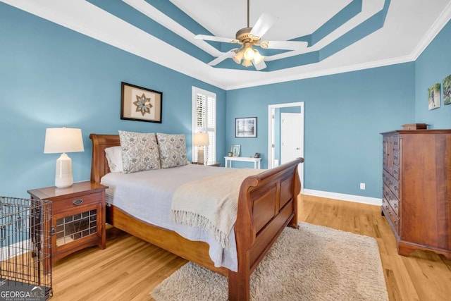 4463 N Gate Dr, Gainesville, GA 30506 - bedroom with ornamental molding, a tray ceiling, baseboards, and wood finished floors