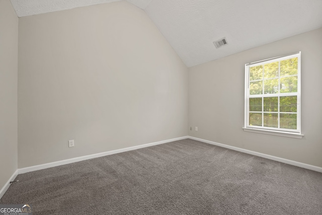 60 Charlotte Blvd, Stockbridge, GA 30281 - empty room featuring lofted ceiling, carpet flooring, a textured ceiling, and baseboards