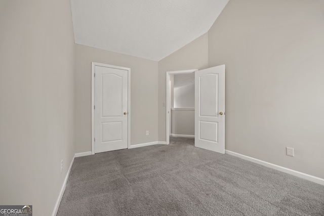 60 Charlotte Blvd, Stockbridge, GA 30281 - unfurnished bedroom featuring vaulted ceiling, baseboards, and carpet