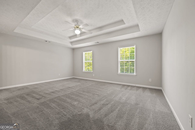 60 Charlotte Blvd, Stockbridge, GA 30281 - carpeted spare room featuring baseboards, a tray ceiling, a textured ceiling, and ceiling fan