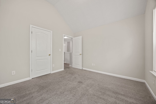 60 Charlotte Blvd, Stockbridge, GA 30281 - unfurnished bedroom featuring lofted ceiling, baseboards, and carpet