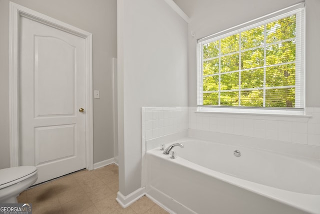 60 Charlotte Blvd, Stockbridge, GA 30281 - full bathroom with a garden tub, toilet, and baseboards