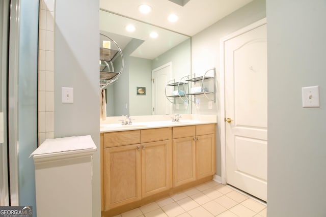full bath featuring double vanity, a sink, tile patterned floors, and recessed lighting