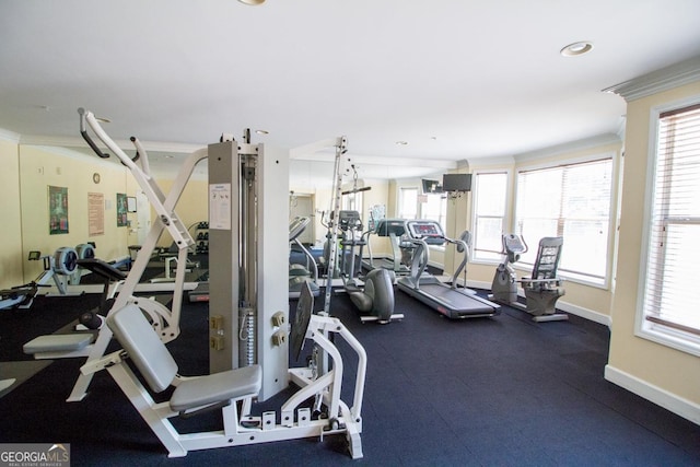gym featuring baseboards, ornamental molding, and recessed lighting