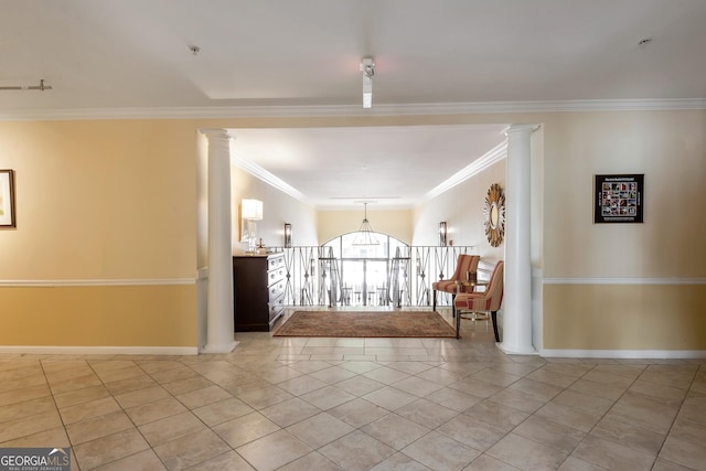 foyer featuring light tile patterned flooring, crown molding, and baseboards