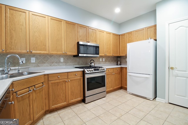 kitchen featuring backsplash, light countertops, a sink, and appliances with stainless steel finishes