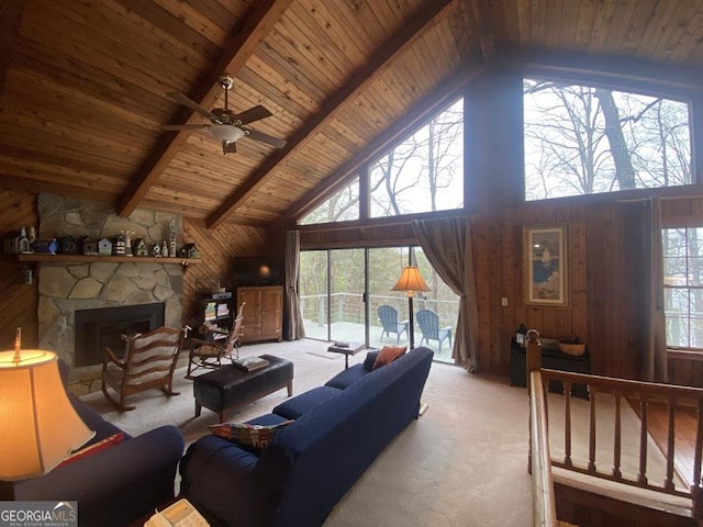 364 Cardinal Ln, Toccoa, GA 30577 - carpeted living area with high vaulted ceiling, wood walls, wood ceiling with exposed beams, a fireplace, and a ceiling fan