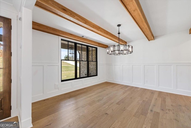 100 Forest Pl, Forsyth, GA 31029 - unfurnished dining area with a decorative wall, beam ceiling, a chandelier, light wood finished floors, and wainscoting