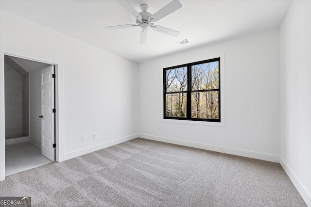 100 Forest Pl, Forsyth, GA 31029 - empty room featuring light carpet, a ceiling fan, and baseboards