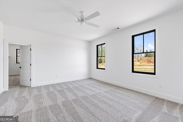 100 Forest Pl, Forsyth, GA 31029 - empty room featuring light colored carpet, baseboards, and a ceiling fan