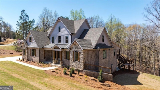 100 Forest Pl, Forsyth, GA 31029 - view of front of property with covered porch, a front lawn, a shingled roof, board and batten siding, and stone siding