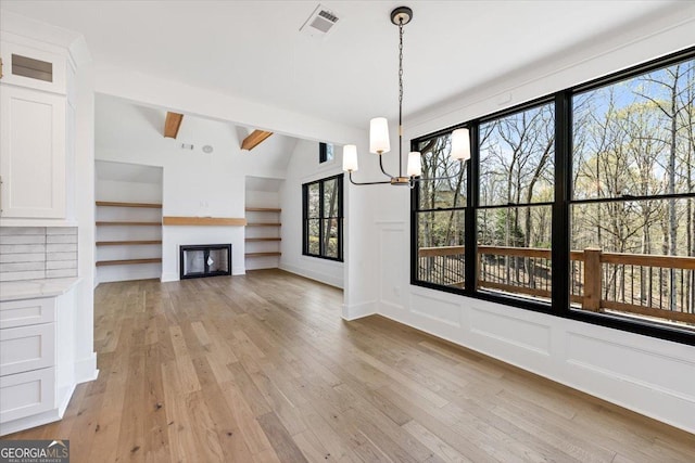 100 Forest Pl, Forsyth, GA 31029 - unfurnished living room featuring light wood finished floors, a fireplace, a chandelier, and built in shelves