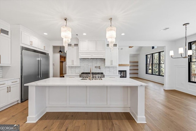 100 Forest Pl, Forsyth, GA 31029 - kitchen featuring a chandelier, built in refrigerator, decorative backsplash, and recessed lighting