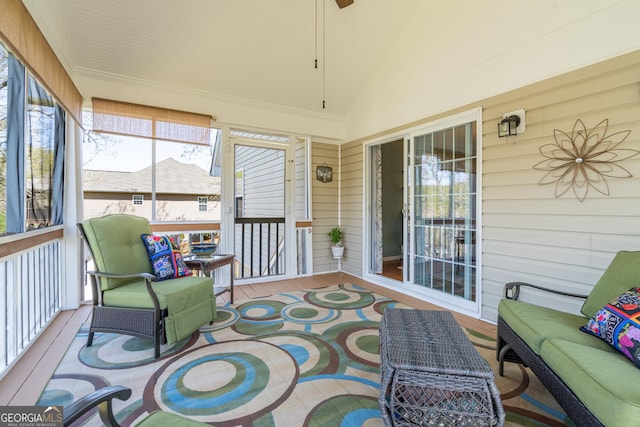 sunroom / solarium featuring ceiling fan