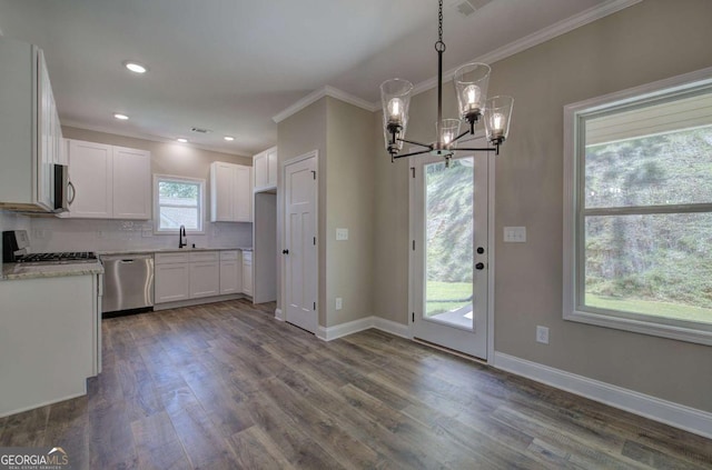 kitchen with ornamental molding, a sink, an inviting chandelier, and appliances with stainless steel finishes