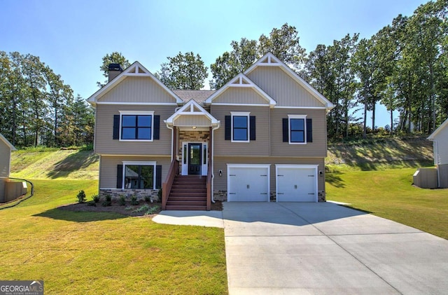 raised ranch featuring concrete driveway, stone siding, a chimney, a front yard, and an attached garage