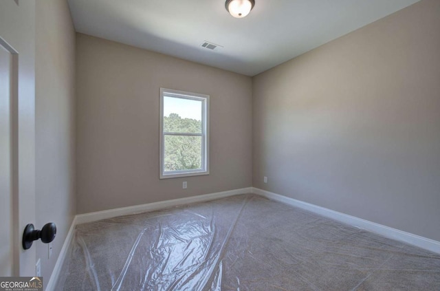 unfurnished room with visible vents, carpet, and baseboards