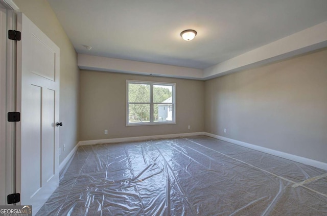 spare room featuring baseboards