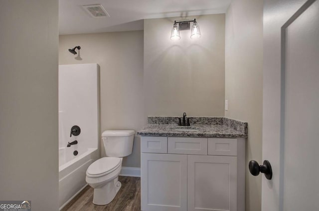 full bath featuring visible vents, baseboards, toilet, wood finished floors, and vanity