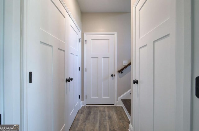 interior space featuring baseboards and dark wood finished floors