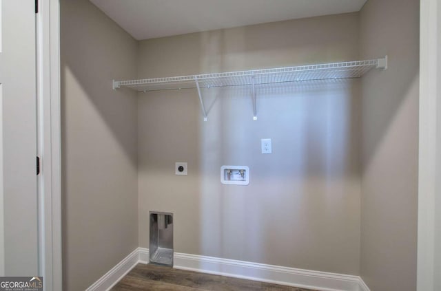 laundry room with hookup for an electric dryer, laundry area, dark wood-type flooring, hookup for a washing machine, and baseboards
