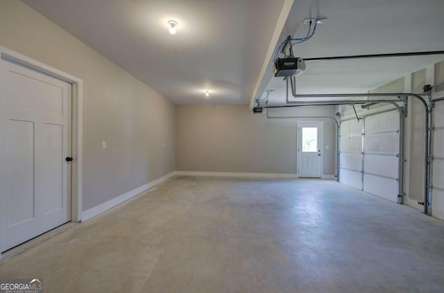 garage with a garage door opener and baseboards
