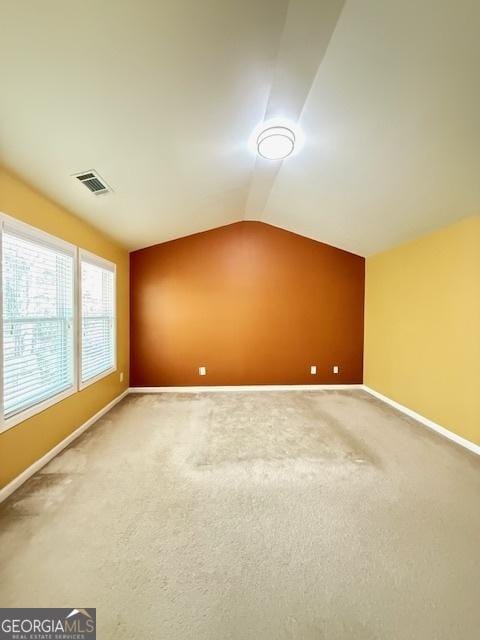 bonus room with baseboards, visible vents, lofted ceiling, and carpet