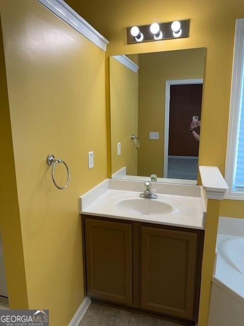 full bath with tile patterned flooring, vanity, and a bath