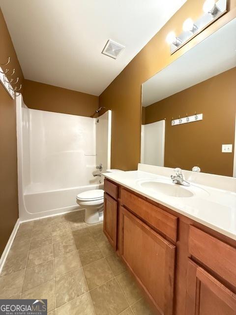 full bath featuring visible vents, toilet, vanity, shower / bathing tub combination, and tile patterned flooring