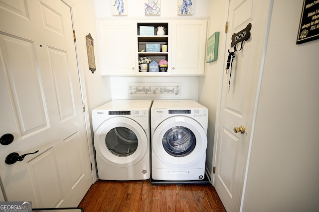 laundry area with dark wood-type flooring, cabinet space, and washing machine and clothes dryer