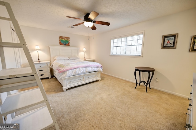 carpeted bedroom featuring baseboards, a textured ceiling, and a ceiling fan