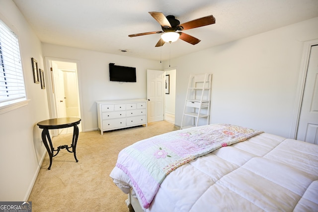 bedroom with light carpet, baseboards, and ceiling fan