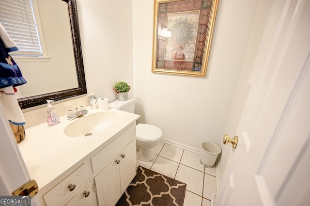 bathroom with tile patterned floors, toilet, baseboards, and vanity
