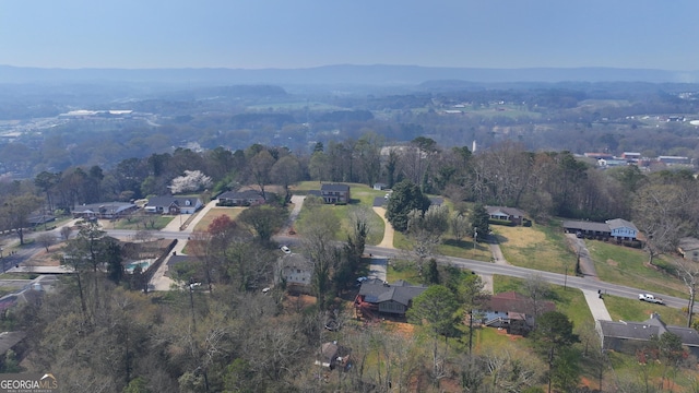 birds eye view of property featuring a forest view