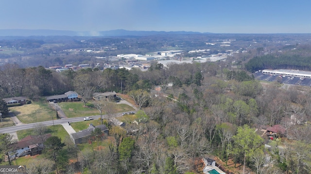birds eye view of property featuring a wooded view