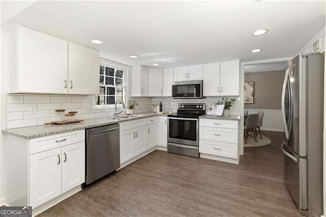 kitchen featuring white cabinetry, dark wood-style floors, a sink, and appliances with stainless steel finishes